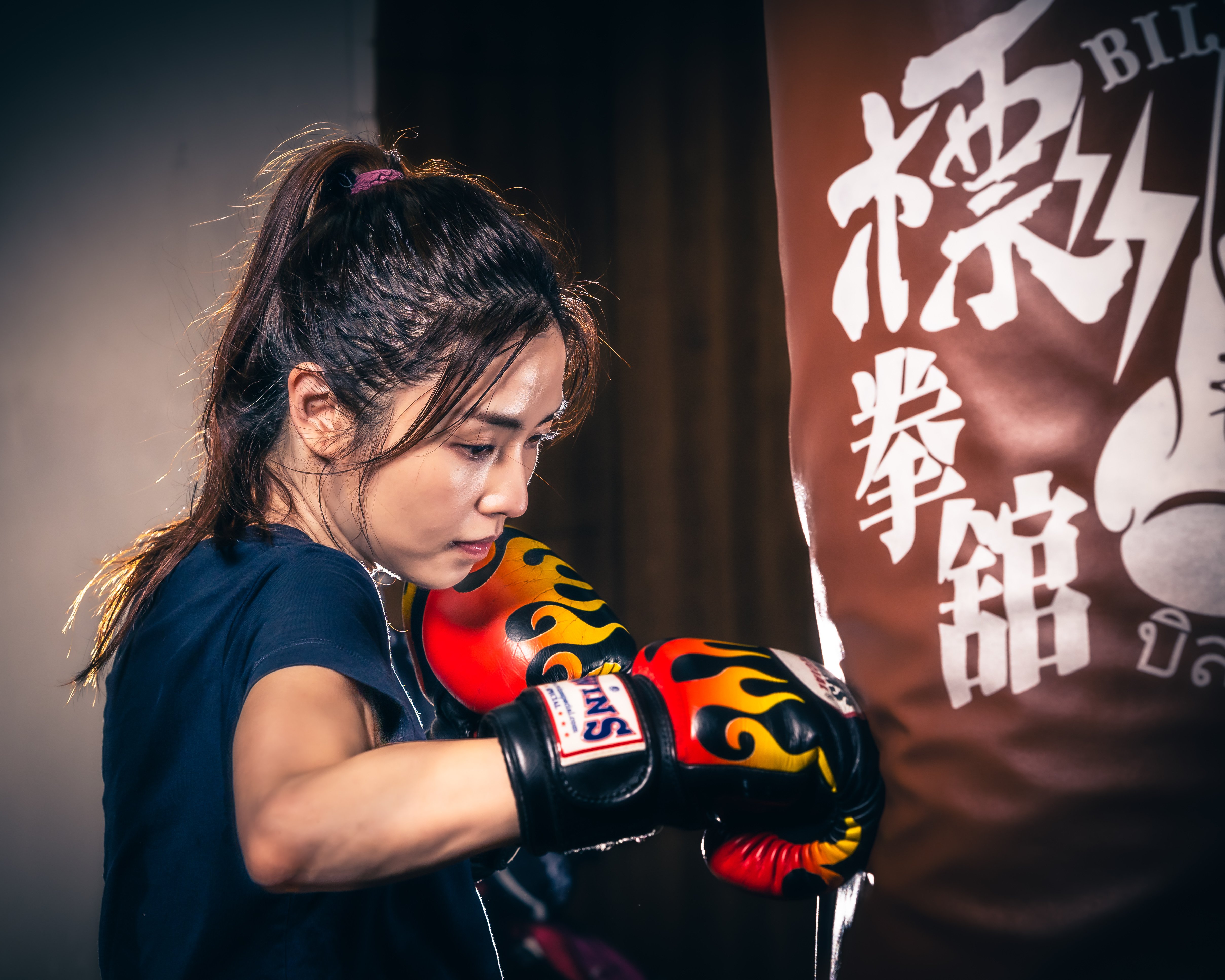 girl punching punching bag